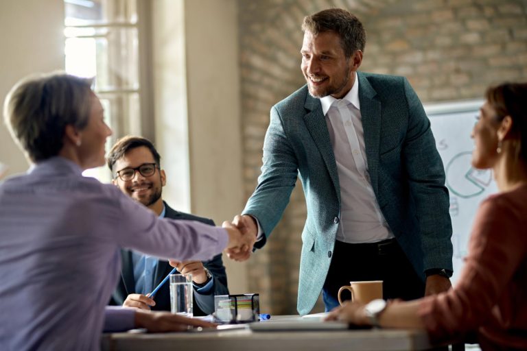 business-coworkers-shaking-hands-during-meeting-office-focus-is-businessman